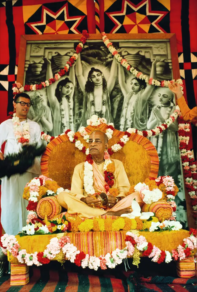 Srila Prabhupada in Balboa Park, San Diego Playing Kartals on Yellow Vyasasana in front of Big Panca-Tattva Painting