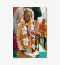 Prabhupada at Airport Holding Plate Covered with Silver Foil and Red Rose